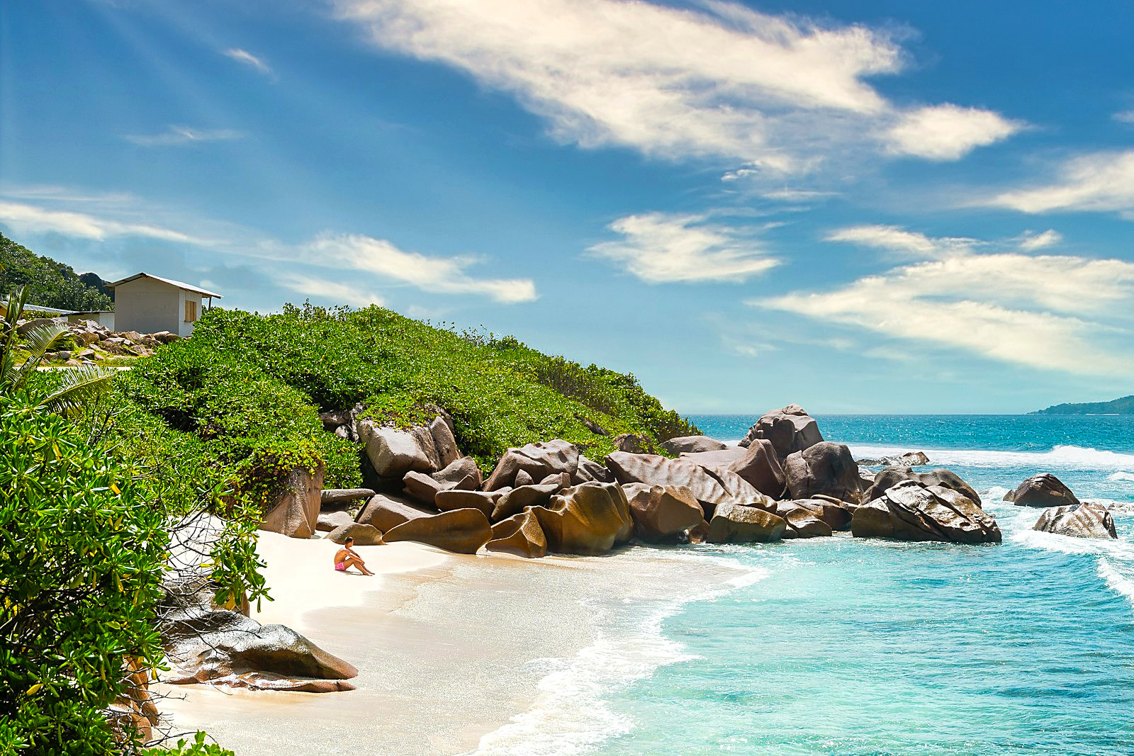 Secluded Anse Major beach cove framed by granite boulders and palms